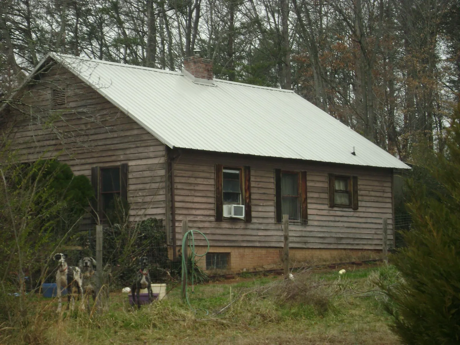White metal roof on an old wood sided farmhouse, from a Metal Roof Installation job in Clarks Hill